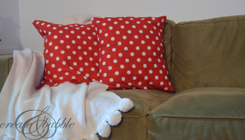 Coussin de Noël habillé d’une housse rouge à pois blancs cousue maison