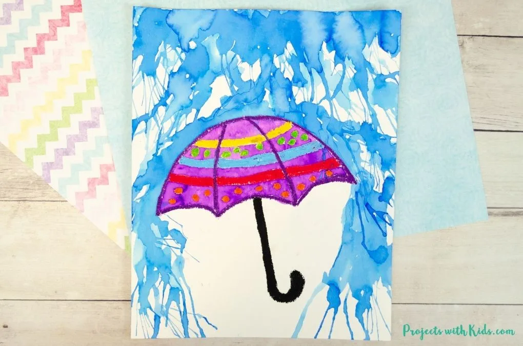 Parapluie violet peint à l’aquarelle sur une illustration de pluie bleue